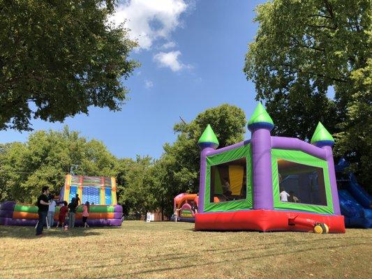 Kids Inflatables area with a tent (shaded tables and seating area) and tall trees for more shade.