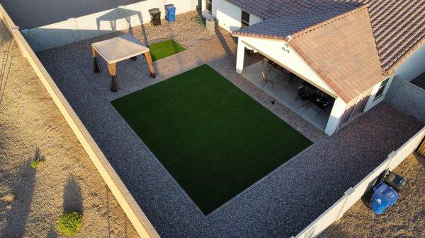 Grass, concrete paver, decorative rock and pergola