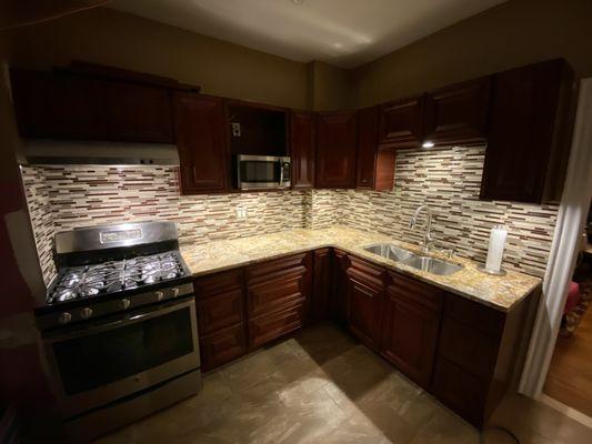 Cherry finished cabinets with backsplash