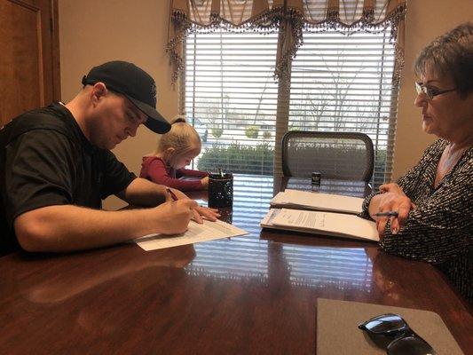 The whole Henley family gets involved in the signing of paperwork!