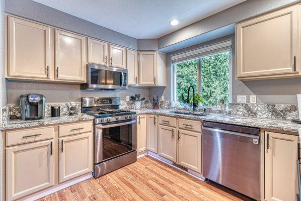 Kitchen cabinet refinish and a unique quartz countertop with matching backsplash and window sill. We did all from start to finish.