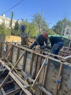 Pouring ready mix concrete in retaining walls