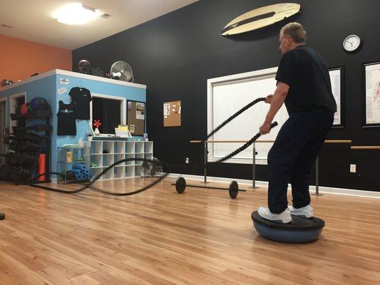 70 years of age on the bosu ball working the ropes. He has over come a rotator cuff injury and ankle injury