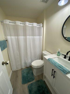 After...spare bathroom.  New mirror, vanity, and toilet were installed.