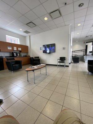 Waiting area with tv and seats for customers