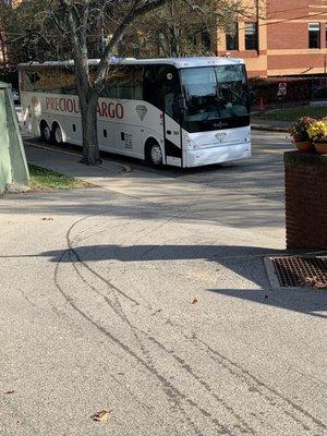 Bus illegally parked and blocking drive way.