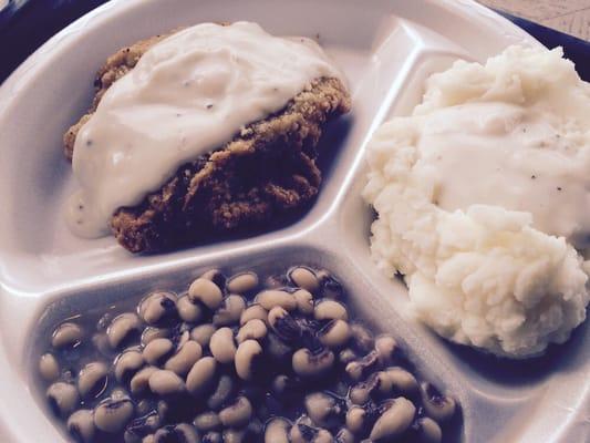 Chicken fried steak, mashed potatoes and peas