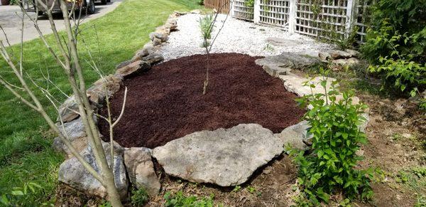 Bed cleanup, boulder border, fresh mulch and rock, and new plants