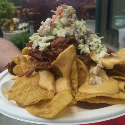 BBQ Nachos with hand made beer cheese sauce and topped with a celery seed coleslaw.