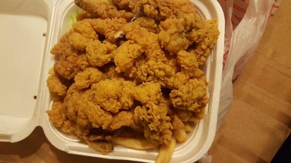 Seafood platter with fish, shrimp, oysters, fries, and rice.  However, it looks like the plates have gotten smaller.