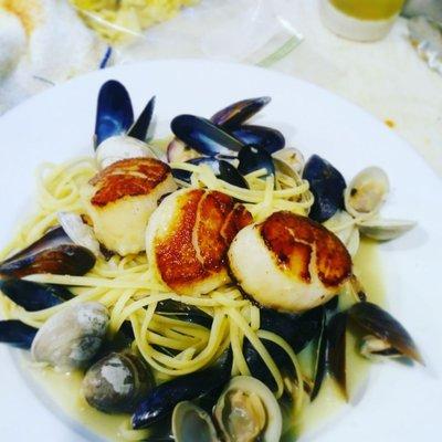 Clams and mussels linguine top with seared scallops.