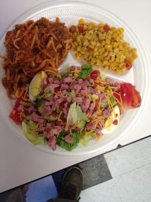 Spaghetti plate with loaded side salad and Mexican corn