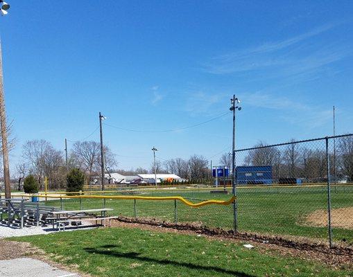 baseball field with lighting and bleachers and a concession stand