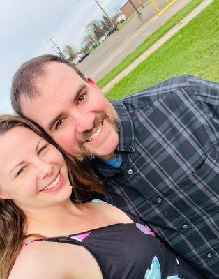 My wife and I standing outside on college grounds.