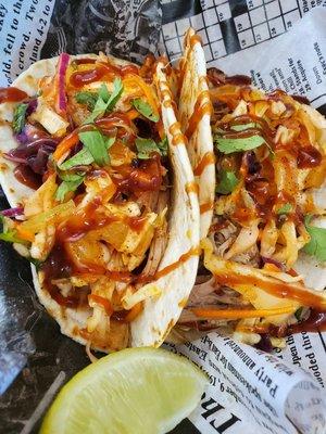 Pulled pork tacos with a spicy pineapple slaw and drizzled with bbq sauce!