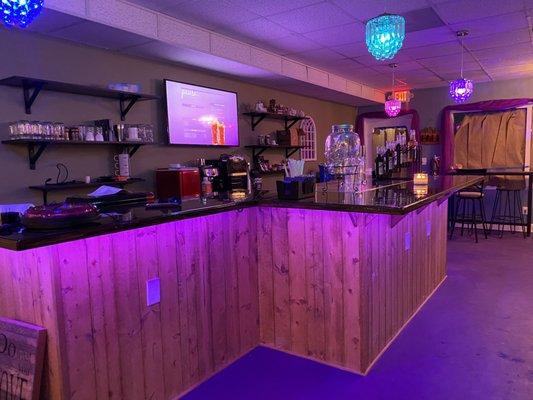 Kava bar with colorful lights overhead and under the bar in Deerfield Beach