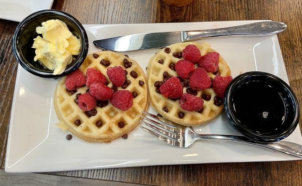 Mini waffles with raspberries and chocolate chips.