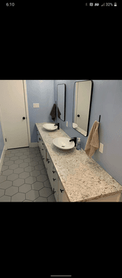 We set up the bathroom vanity with Quartz Wave and vessel sinks which we also installed.