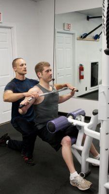 lat pull downs  make sure your able to squeeze your shoulder blades for that 2 second contraction. if you can't your going to heavy...