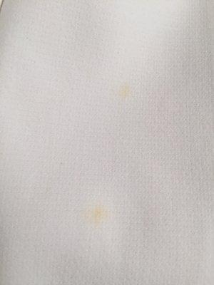 Two yellow spots/stains/burn marks that weren't there when I dropped the coat off.