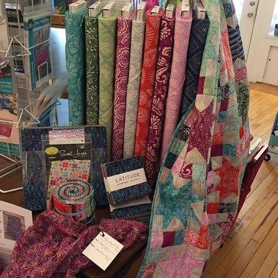 We carry Batiks fabrics as well as regular high quality quilting fabrics, and knits, as well as smaller selections of flannels.