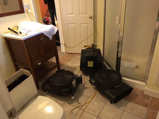 Our high powered air movers and low amp hybrid air movers drying out a flooded bathroom