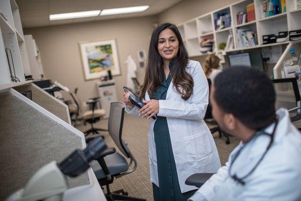 Dr. Reena Patel chats with fellow oncologist Dr. JP Blaize.