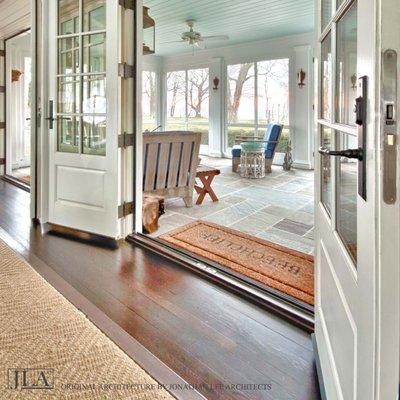 French doors open to screened porch in Saugatuck Michigan residence. Design by Jonathan Lee Architects. #jlaarch