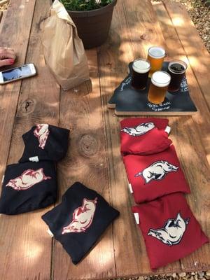 Cornhole and picnic tables outside.