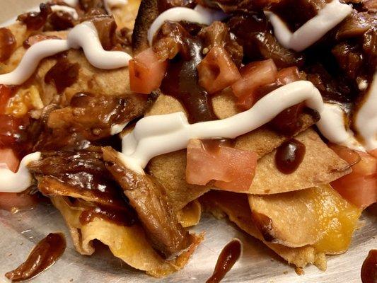 Pulled Pork Nachos. Hearty fresh chips, layers of home made pulled pork and melted cheese. Delicious!