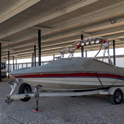 Boat storage underneath a metal canopy.