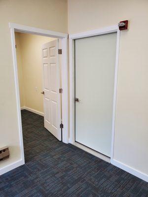 Installed new doors, trim, and carpet squares for a retail customer.