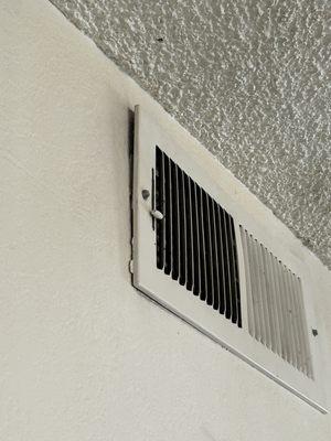 Vent cover bent away from the wall