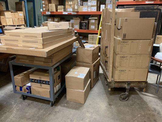 Boxes on carts, shelving and pallet racking. Warehousing and storage of cartons of inventory for fulfillment for a client.