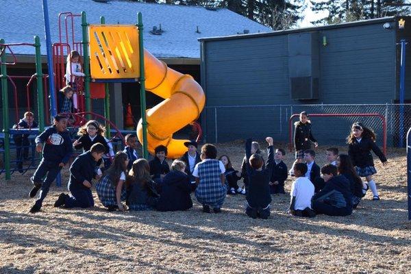 Kids from many grades participating in Duck Duck Goose before school!