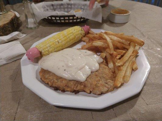 Chicken Fried Steak, corn on the cob and french fries.