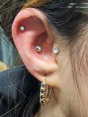 Conch, Helix, and Tagus piercings all with cz tops to match the daith heart on the other side.