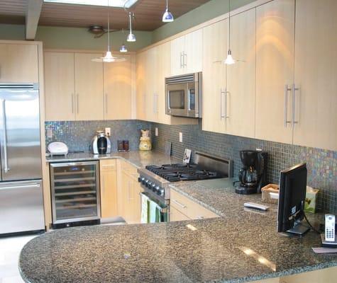 Custom kitchen in sequenced maple veneer.