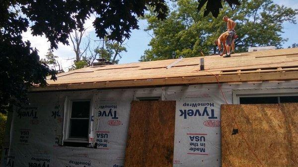 The team replacing bad wood on the roof.That is  Tyvek that is a vapor barrier that goes behind the siding