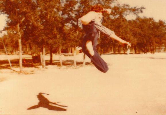 Master Kaufman as a teen, 1983 doing a flying side kick with extreme height and non-kicking leg folded way up.