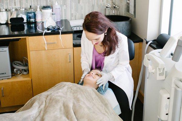 Dr. Tendler performing a skin care treatment