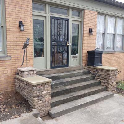 Covered up brick Wing walls with dry stack cultured stone and made a Stone box for their bronze parrot