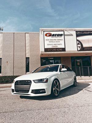 Fixed car in front of shop.