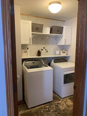 Laminate countertops, cabinets, and hanging rod.