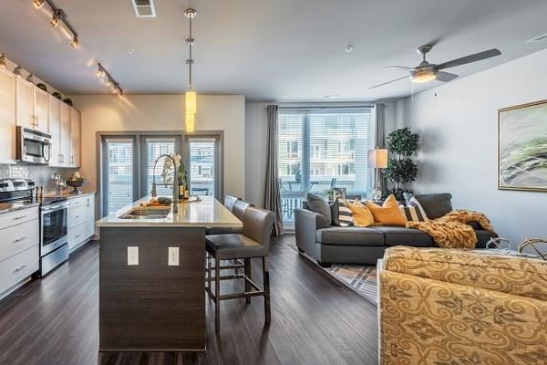 Open floor plans with wood plank flooring and floor to ceiling windows.