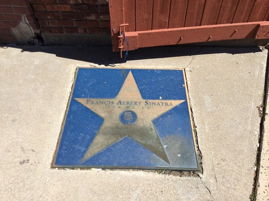 Plaque on the sidewalk.