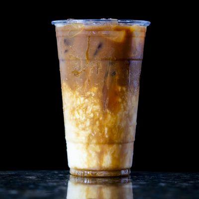 Iced Caramel Macchiato - (Most Popular) Espresso over Ice with a splash of vanilla, your choice of whole or oat milk, and caramel drizzle.