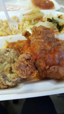 Smothered fried chicken,  cabbage, mac and cheese,  and dressing.