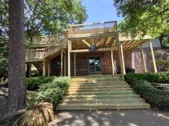 front view of a 2 story deck we with stairs and stairwell