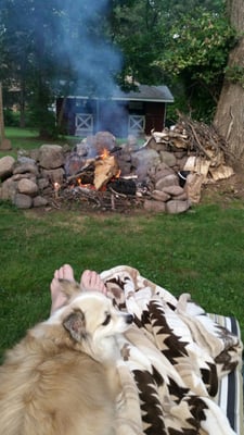 Bailey getting to stretch out and enjoy the fire and the outdoors while being at Linda's!